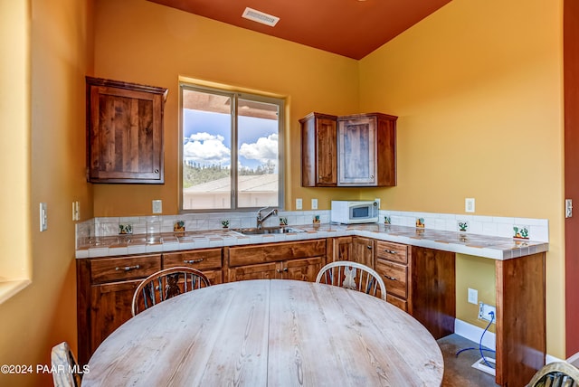 kitchen featuring tile counters and sink