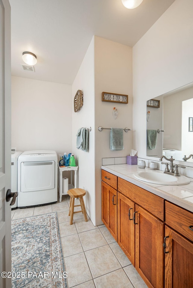 bathroom with visible vents, vanity, and tile patterned flooring