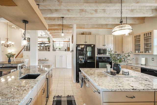 kitchen featuring black appliances, beamed ceiling, a kitchen island, and a sink