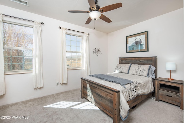 bedroom with visible vents, ceiling fan, and carpet