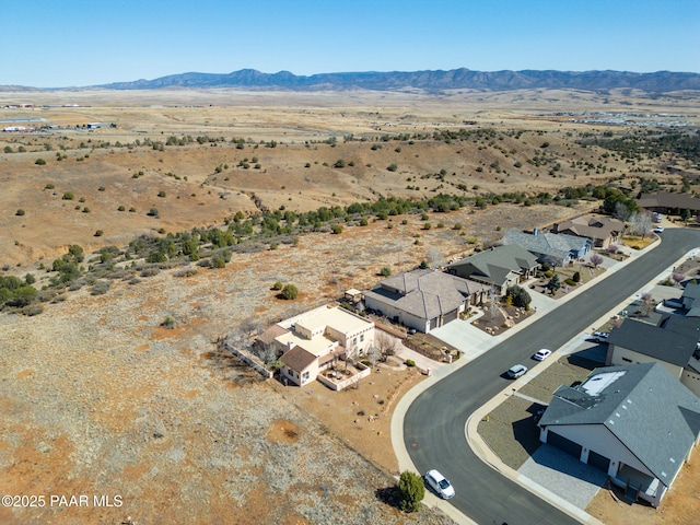 birds eye view of property featuring view of desert and a mountain view