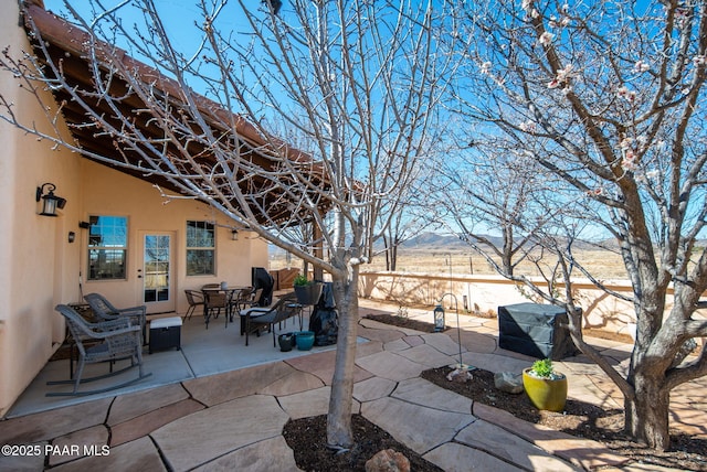 view of patio / terrace featuring a mountain view and fence