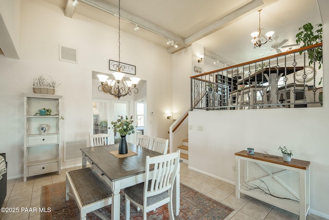 tiled dining area featuring a chandelier, visible vents, stairway, and a high ceiling