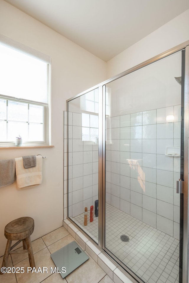 bathroom with tile patterned floors and a stall shower