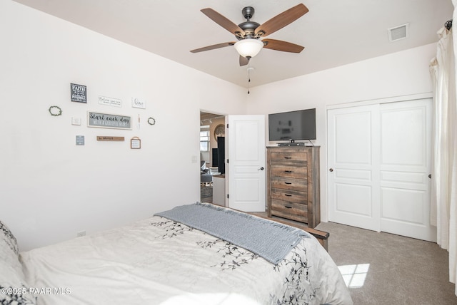 bedroom with visible vents, a closet, carpet floors, arched walkways, and ceiling fan