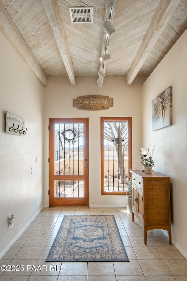 doorway with beam ceiling, visible vents, tile patterned floors, and wood ceiling