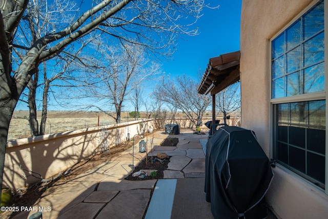 view of patio / terrace with grilling area and fence