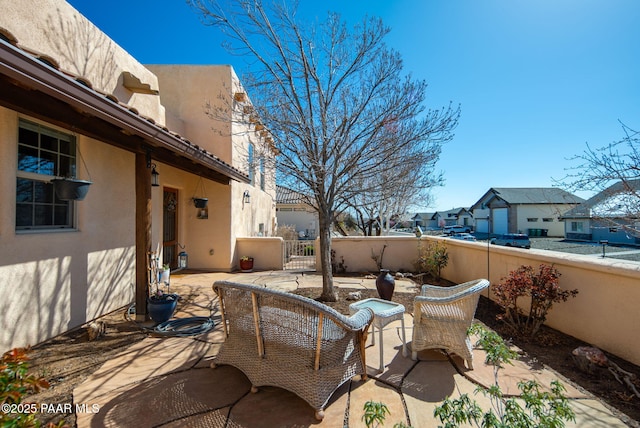 view of patio with a residential view and fence