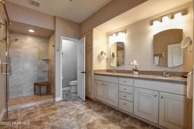 1716 Alpine Meadows Ln Unit 1402, Prescott, AZ 86303 - bathroom featuring toilet, a stall shower, double vanity, and baseboards