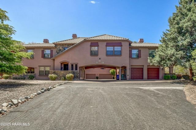 1716 Alpine Meadows Ln Unit 1402, Prescott, AZ 86303 - mediterranean / spanish-style house with a chimney, a garage, stucco siding, and driveway