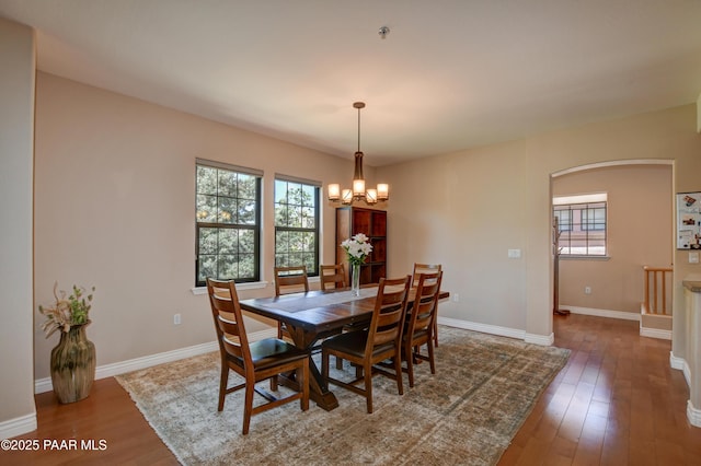 1716 Alpine Meadows Ln Unit 1402, Prescott, AZ 86303 - dining area featuring a chandelier, healthy amount of natural light, hardwood / wood-style flooring, and baseboards