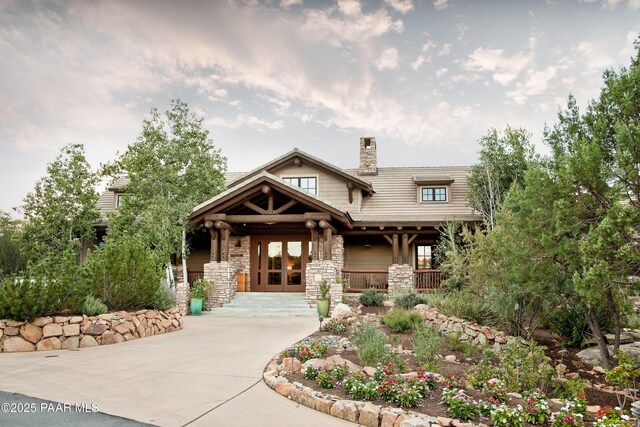 1716 Alpine Meadows Ln Unit 1402, Prescott, AZ 86303 - craftsman house featuring covered porch, stone siding, a chimney, and french doors