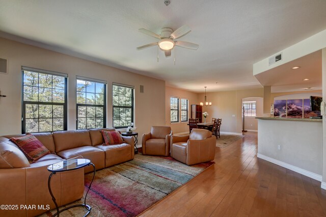 1716 Alpine Meadows Ln Unit 1402, Prescott, AZ 86303 - living area featuring ceiling fan, baseboards, dark wood-type flooring, a chandelier, and arched walkways