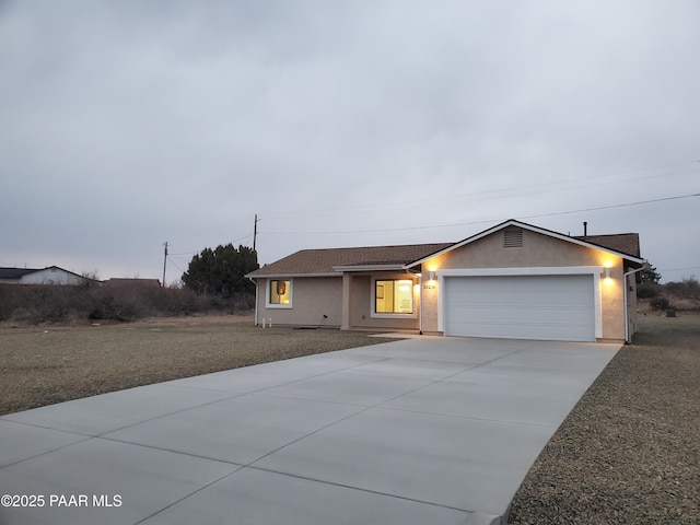 ranch-style home featuring a garage and a front lawn