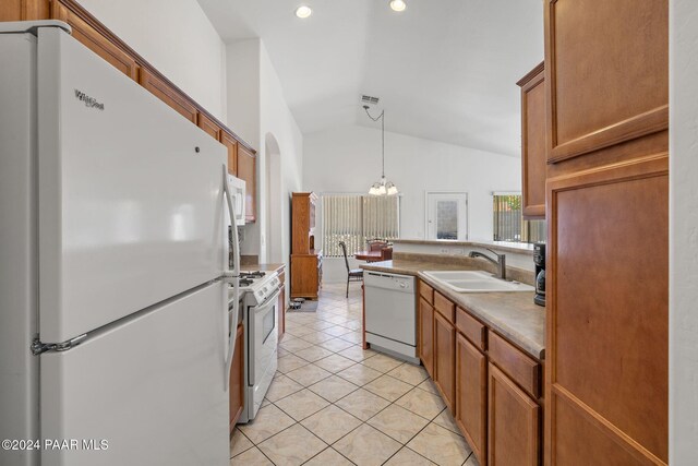 kitchen featuring sink, hanging light fixtures, lofted ceiling, white appliances, and light tile patterned floors