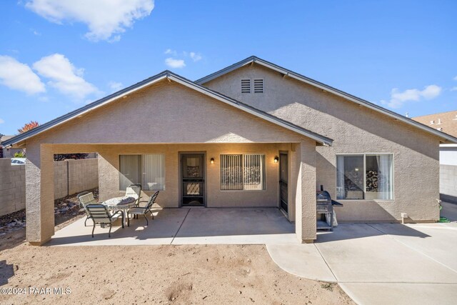 back of property with a patio