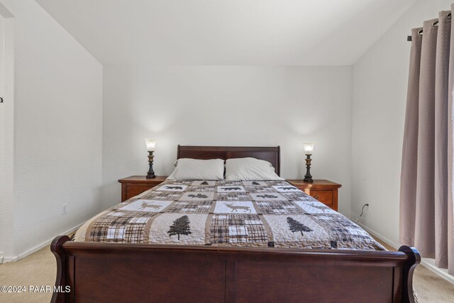 bedroom with carpet and lofted ceiling