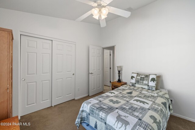 carpeted bedroom featuring ceiling fan and a closet