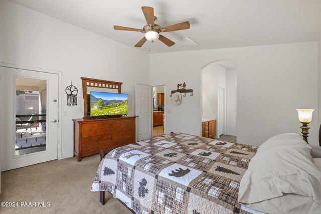 carpeted bedroom with ceiling fan and ensuite bathroom