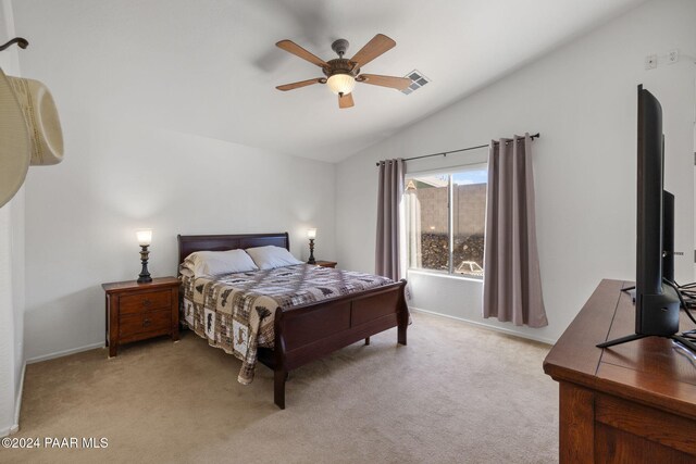 bedroom featuring light carpet, ceiling fan, and vaulted ceiling