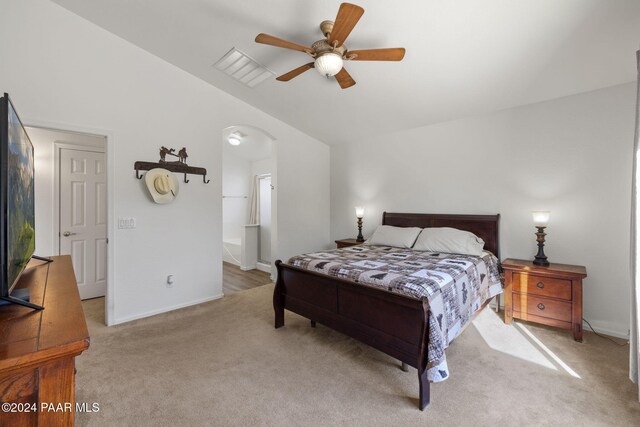 bedroom with light carpet, vaulted ceiling, and ceiling fan