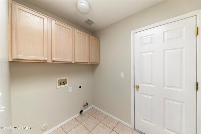 washroom featuring hookup for a gas dryer, cabinets, washer hookup, light tile patterned floors, and electric dryer hookup