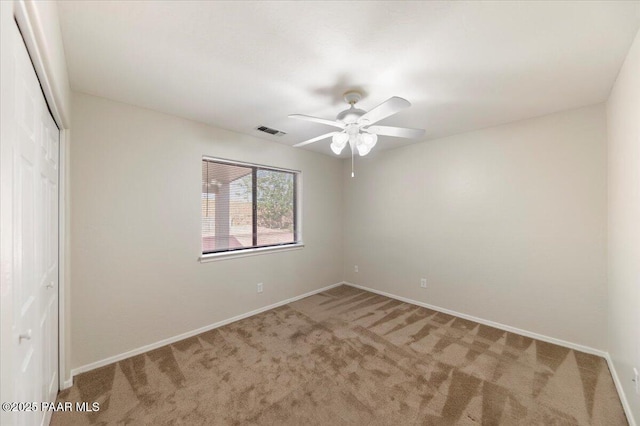 carpeted empty room with ceiling fan