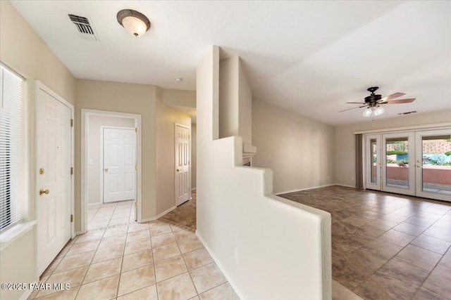 hall with light tile patterned floors and french doors