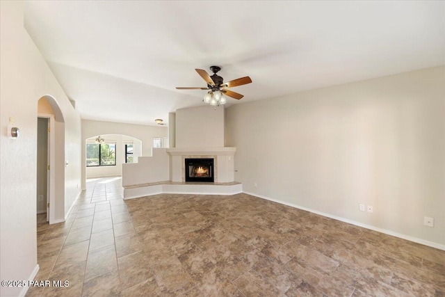 unfurnished living room with light tile patterned floors and ceiling fan