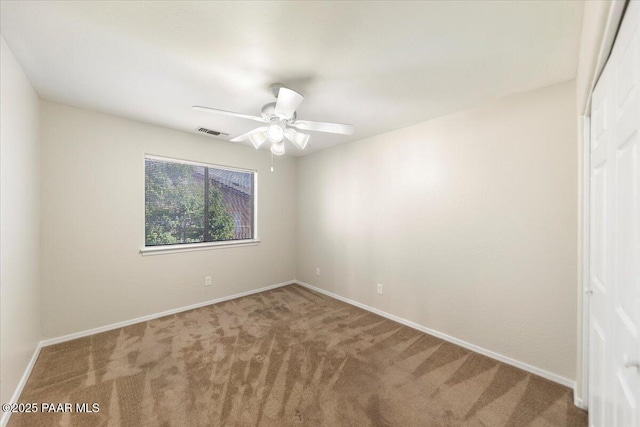 empty room with ceiling fan and carpet