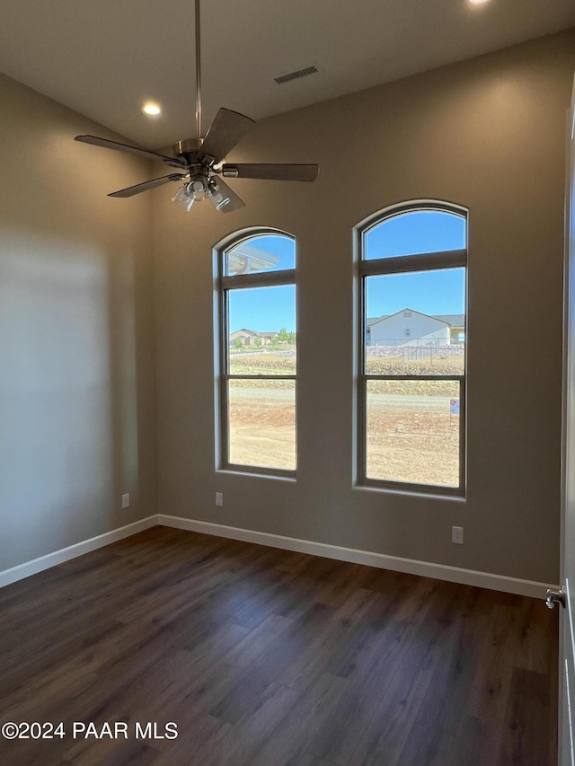 spare room with ceiling fan and dark hardwood / wood-style flooring