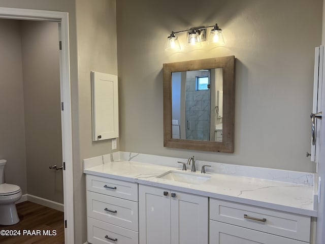 bathroom featuring hardwood / wood-style floors, vanity, and toilet