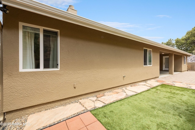 2635 Tolemac Way, Prescott, AZ 86305 - view of side of property featuring a yard, a patio, and stucco siding