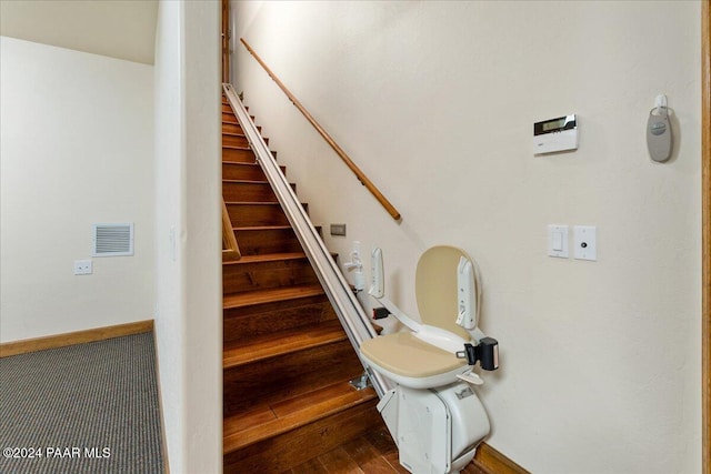 stairs featuring hardwood / wood-style flooring