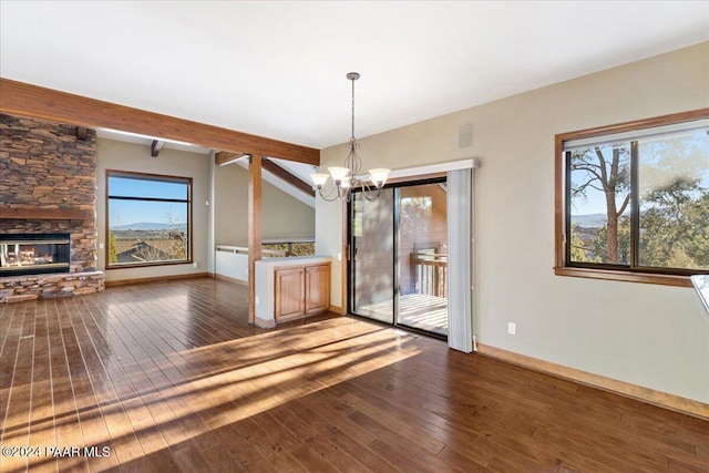 unfurnished dining area featuring a stone fireplace, beamed ceiling, dark wood-type flooring, and an inviting chandelier