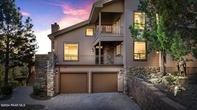 view of front of home featuring a garage and a balcony