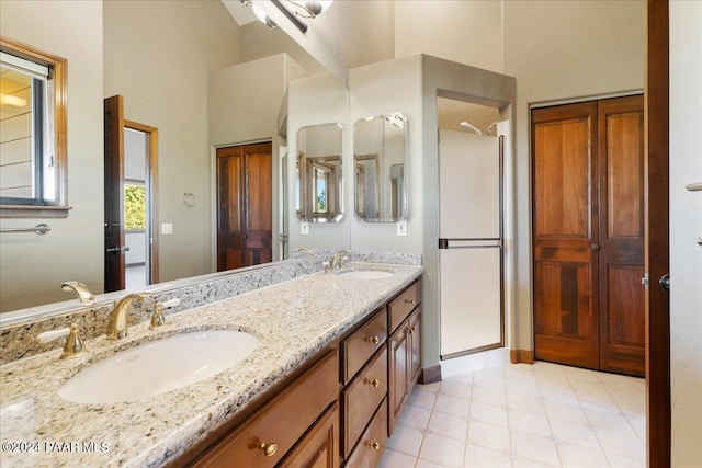 bathroom with vanity and a shower with door