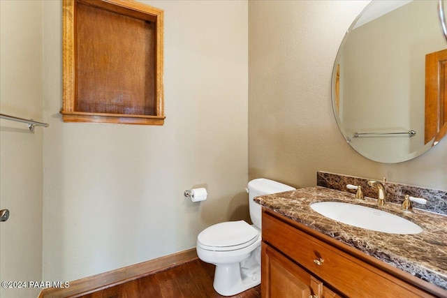 bathroom featuring hardwood / wood-style floors, vanity, and toilet