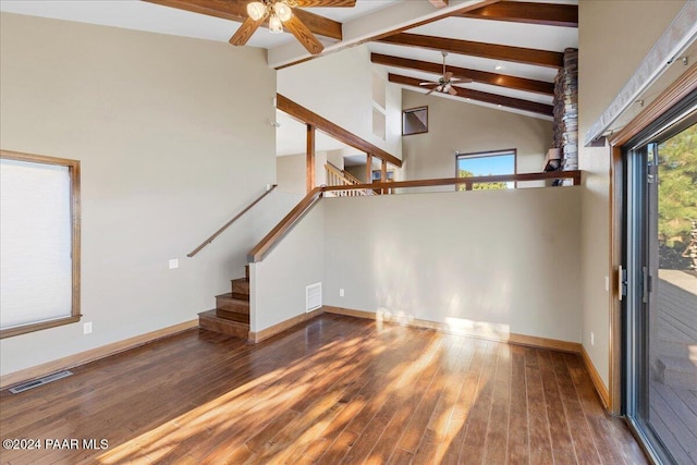 unfurnished living room with hardwood / wood-style floors, high vaulted ceiling, ceiling fan, and beam ceiling