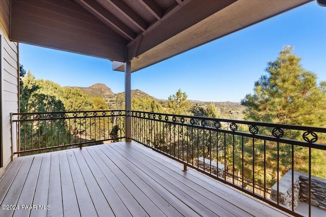 wooden deck with a mountain view