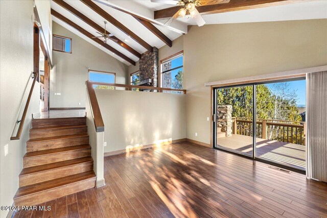 unfurnished living room featuring beamed ceiling, dark hardwood / wood-style flooring, high vaulted ceiling, and ceiling fan