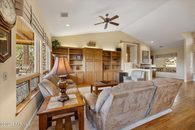 living room featuring vaulted ceiling, ceiling fan, and light hardwood / wood-style floors