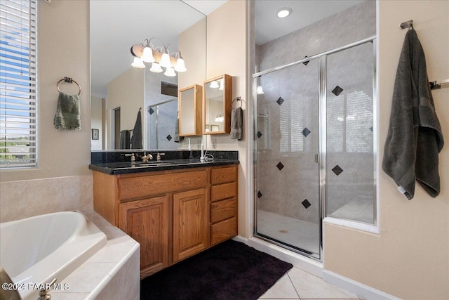 bathroom with tile patterned floors, separate shower and tub, and vanity