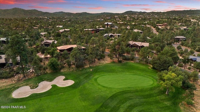 aerial view at dusk featuring a mountain view