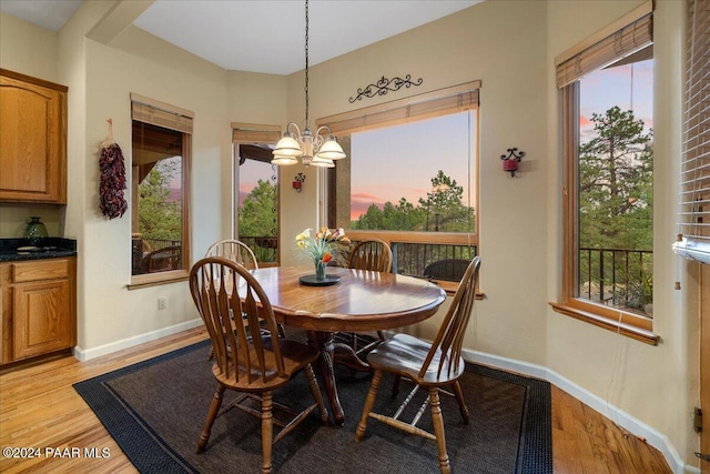 dining space featuring light hardwood / wood-style floors and a notable chandelier