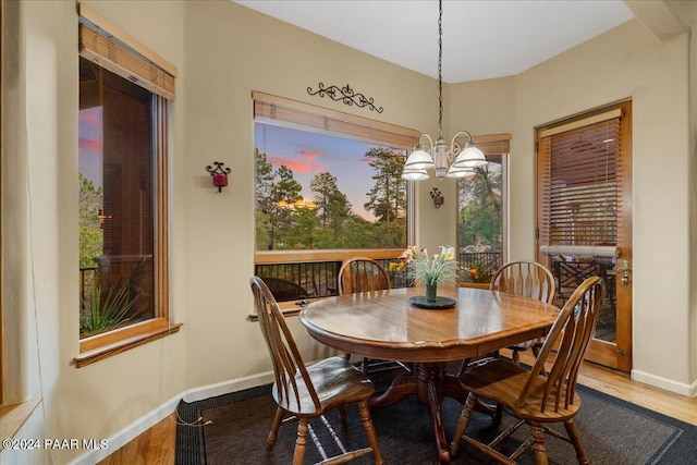 dining room with an inviting chandelier and hardwood / wood-style flooring