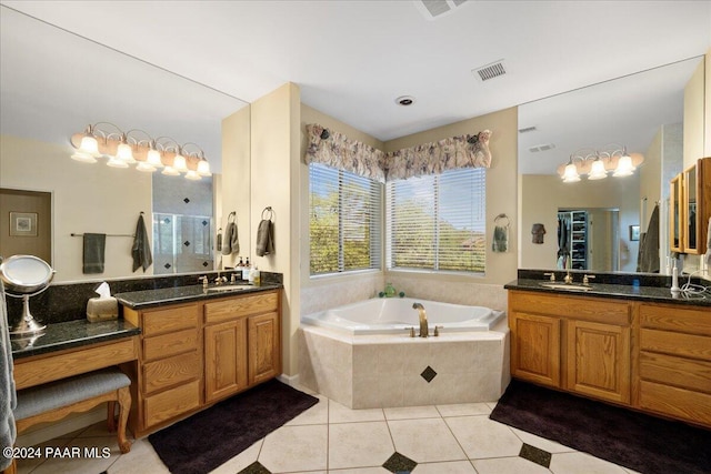 bathroom featuring plus walk in shower, vanity, and tile patterned floors