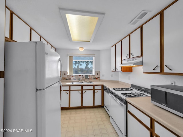 kitchen featuring sink, white cabinets, and stainless steel appliances