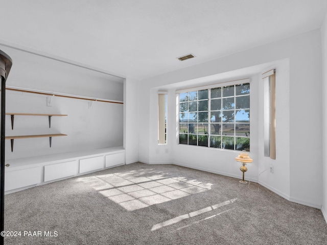 unfurnished room featuring light colored carpet