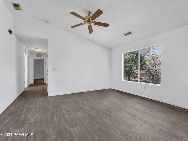 empty room with ceiling fan and dark wood-type flooring